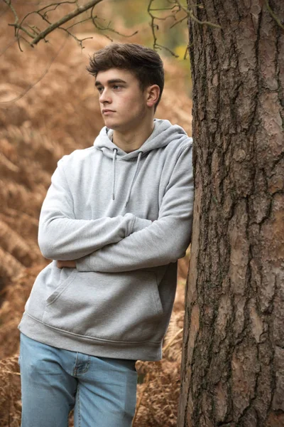 Teenage boy in the woods on an autumn day — Stock Photo, Image
