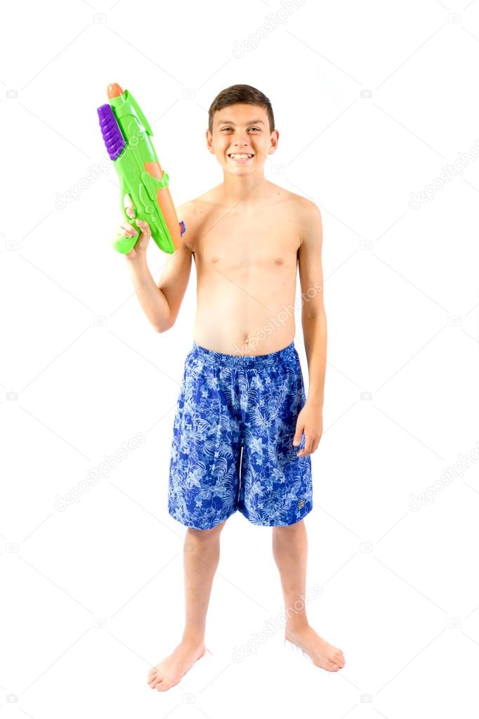 Young teenage boy playing with water guns