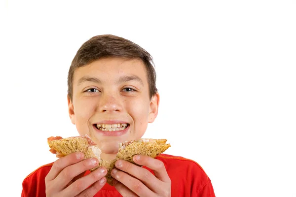 Young caucasian teenage boy with a sandwich — Stock Photo, Image