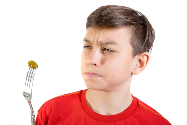 Young caucasian teenage boy doesn't like a food — Stock Photo, Image