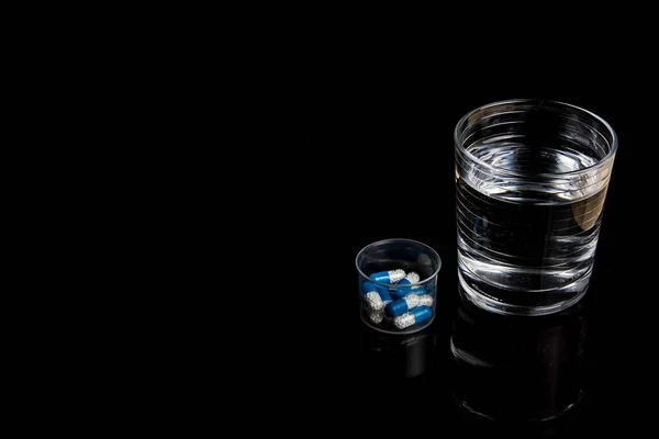 Medical pills isolated on a black background — Stock Photo, Image