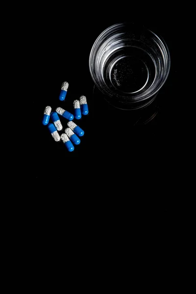 Medical pills isolated on a black background — Stock Photo, Image