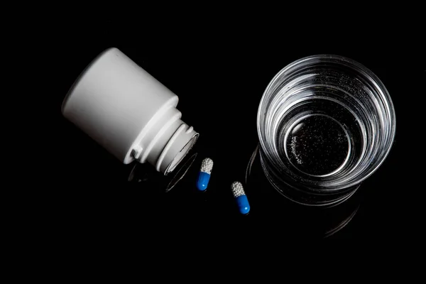 Medical pills isolated on a black background — Stock Photo, Image