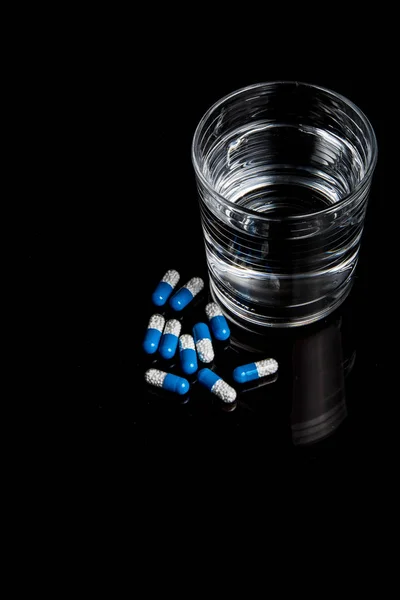 Medical pills isolated on a black background — Stock Photo, Image