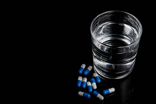 Medical pills isolated on a black background — Stock Photo, Image