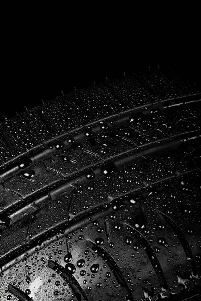 Car tyre isolated on a black background — Stock Photo, Image