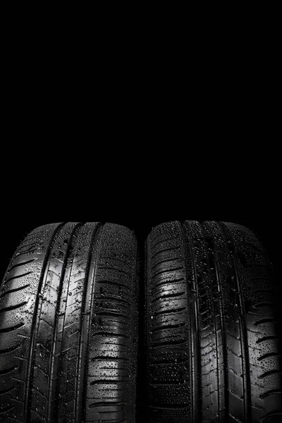 Car tyre isolated on a black background — Stock Photo, Image