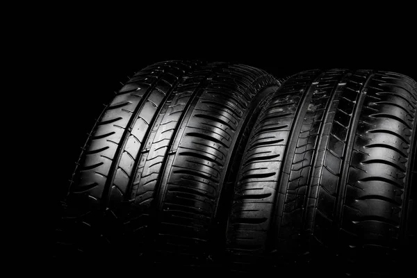 Car tyre isolated on a black background — Stock Photo, Image