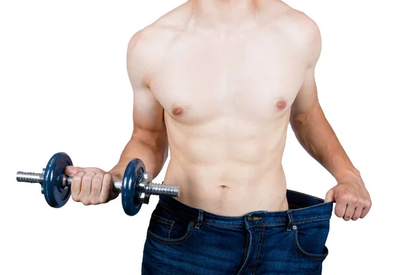 体重ルックのコンセプトを示す筋肉若い男性大人保持置くバギー服と保持ダンベル — ストック写真
