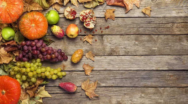 Autumn fruit, banner, leaves on wooden floor