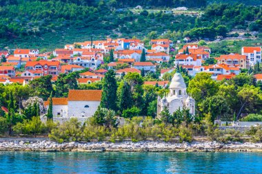 Supetar mausoleum coastline landscape. / Scenic view at coastal town Supetar in Dalmatia region, Croatia. clipart