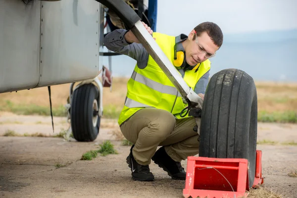 https://st3.depositphotos.com/6456500/12540/i/450/depositphotos_125403720-stock-photo-checking-aircrafts-tire.jpg