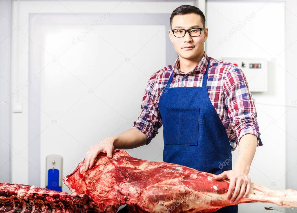 Worker with raw meat