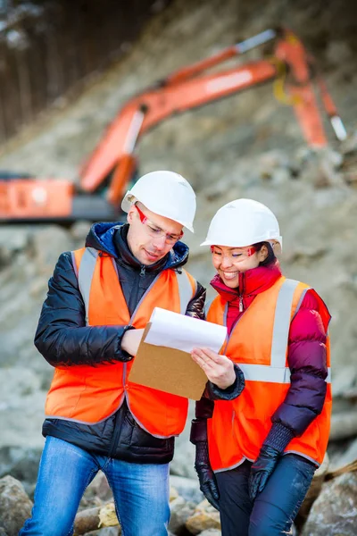 Road workers inspecting construction — Stock Photo, Image