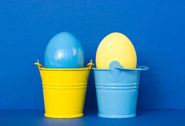 Huevos de Pascua de color azul y amarillo en cubos de colores, imagen de enfoque selectivo. Feliz tarjeta de Pascua — Foto de Stock