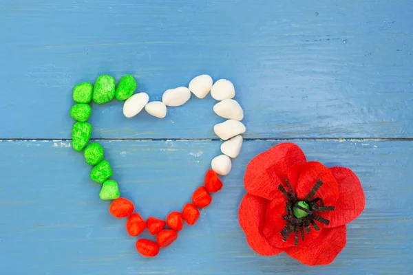 April 25 Liberation Day Text in italian card. Flower poppy and italy flag. selective focus image