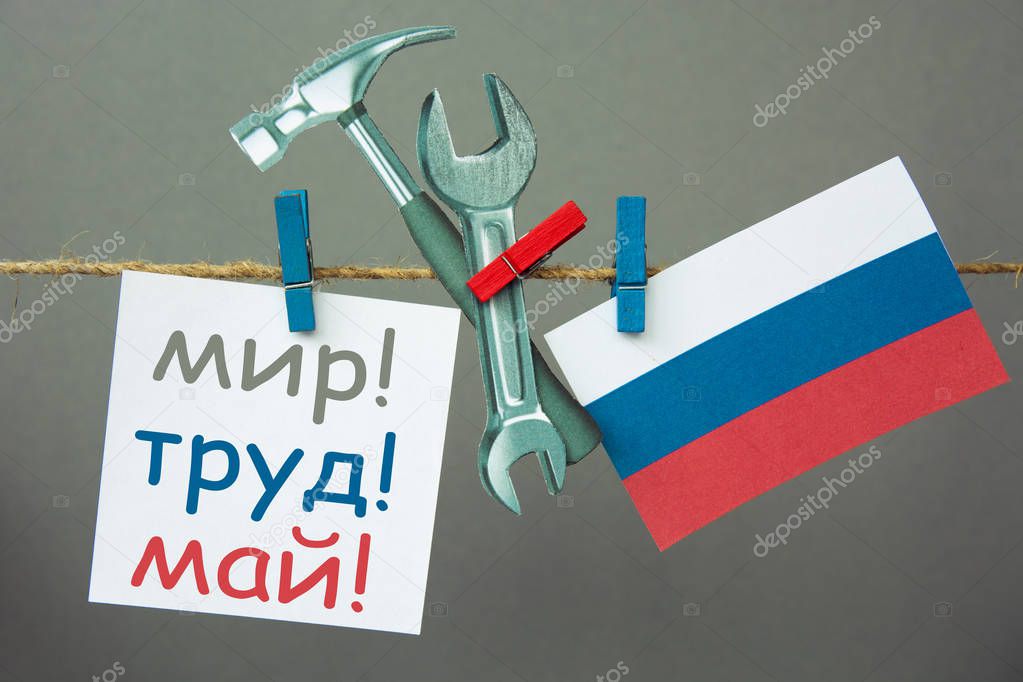Labour day card. Peace, Labor, May in Russian. Hammer and wrench Russia flag