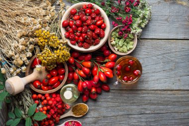 Medicinal plants and herbs composition: Dog rose, bunch branch Rosehips, types Rosa canina hips, essential oil. bunch,Herbal Tea with rosehip, dried flowers of linden and chamomile - pharmacy clipart