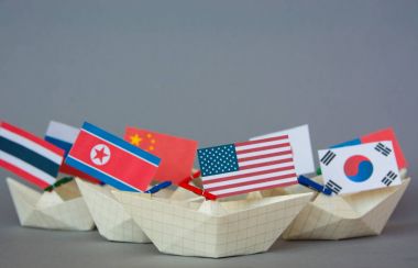 paper ship with Flags of USA, China, North Korea, South Korea, Japan And other East Asian countries clipart