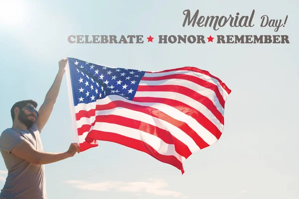 Man is holding waving american USA flag. memorial day card — Stock Photo, Image