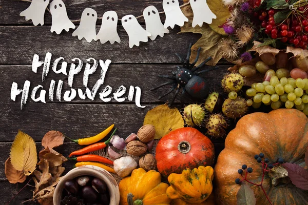 Happy Halloween card. Funny delicious ginger cookie, bag of sweets and candies shape ghost and skeleton with pumpkins and sweets. — Stock Photo, Image