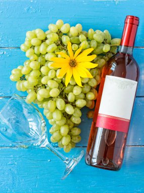 Demet taze olgun beyaz üzüm ve şarap bir mavi ahşap dokusal yüzeyinde. metin reklam alanı
