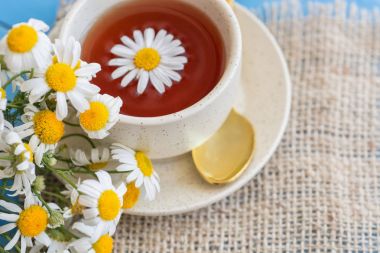 ahşap arka plan üzerinde taze papatya çiçekler ile bitkisel papatya çayı fincan. Doktor tedavi ve Önleme kavramının bağışıklık, tıp - halk, alternatif, tamamlayıcı, geleneksel tıp 