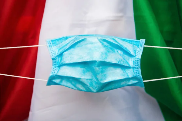 protective face mask against italian flag - Coronavirus concept Pandemic in Italy