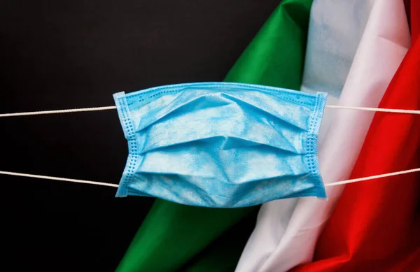 protective face mask against italian flag - Coronavirus concept Pandemic in Italy