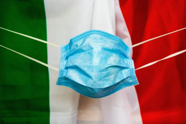 protective face mask against italian flag - Coronavirus concept Pandemic in Italy