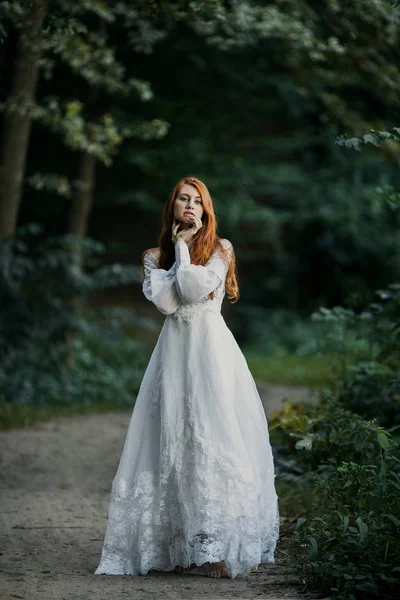 Young sexy redhead woman in white bridal vintage dress Stock Picture