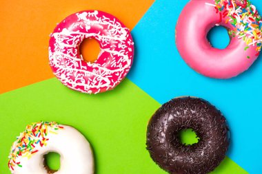 Donuts with icing on colorful texture clipart