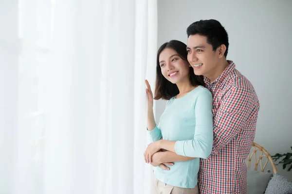 Romantic happy young asian couple relax at modern home indoors