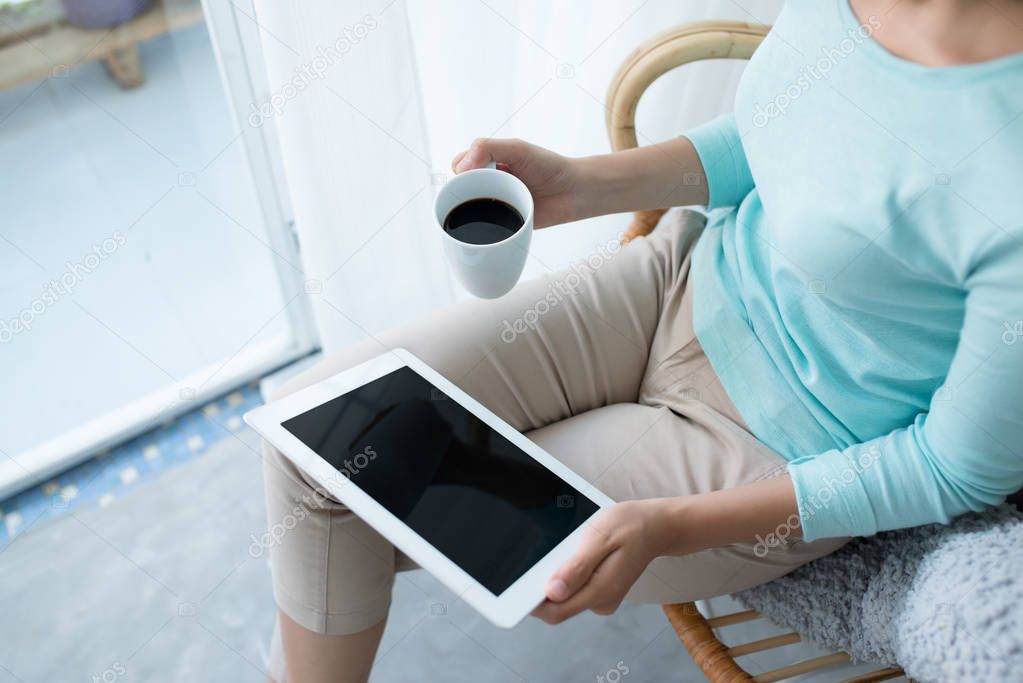woman relaxing and using digital tablet