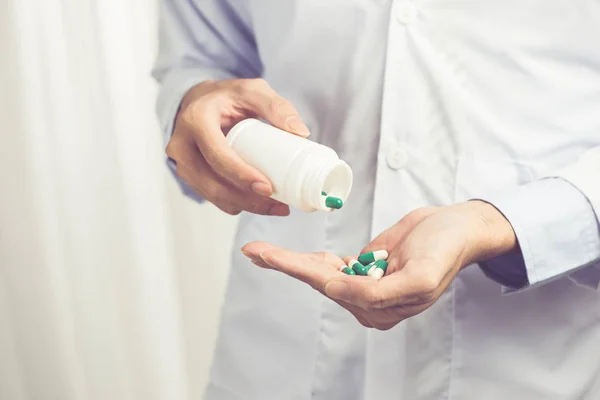 Pill bottle in hands — Stock Photo, Image