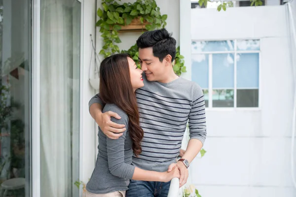 Couple amoureux partageant des émotions authentiques et le bonheur, étreignant sur le balcon — Photo