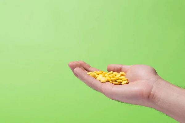 Colored pills in hand