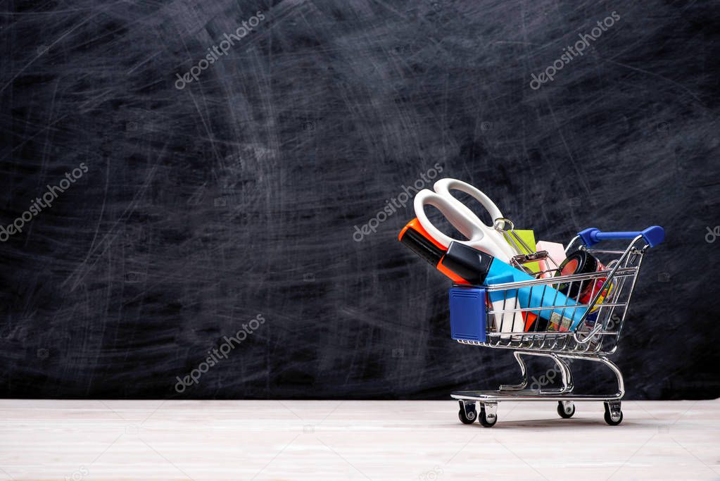 Education, Back to School, Shopping. Shopping cart with school supplies
