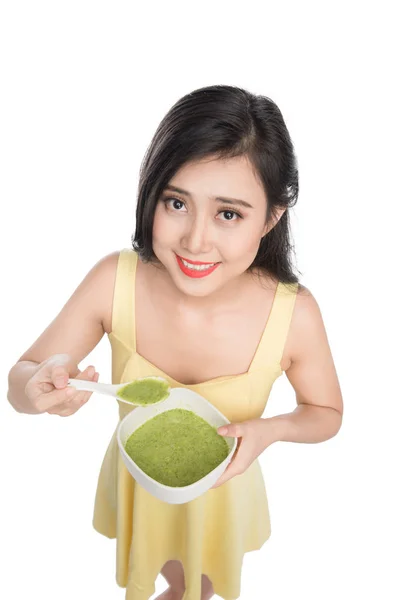 Woman eating plate of green soup — Stock Image Woman eating plate of green soup Royalty Free Stock Photos