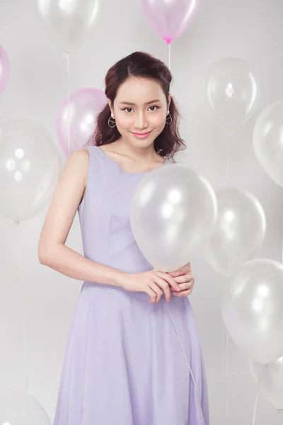 woman with pastel balloons