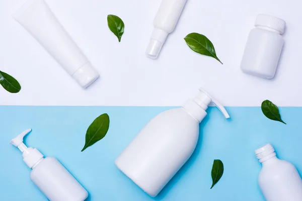 Cosmetics packaging with green leaves — Stock Photo, Image