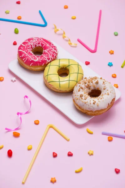 Colourful donuts and party stuff — Stock Photo, Image