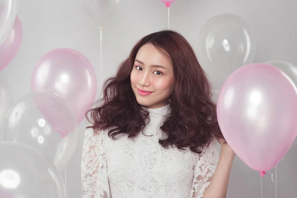 woman with pastel balloons