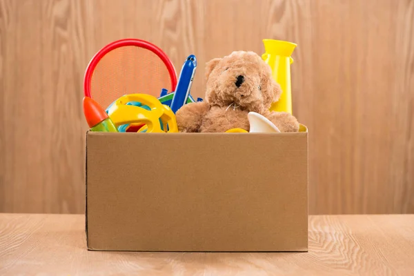 volunteer putting toys in box