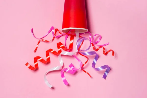 cup with colorful party streamers