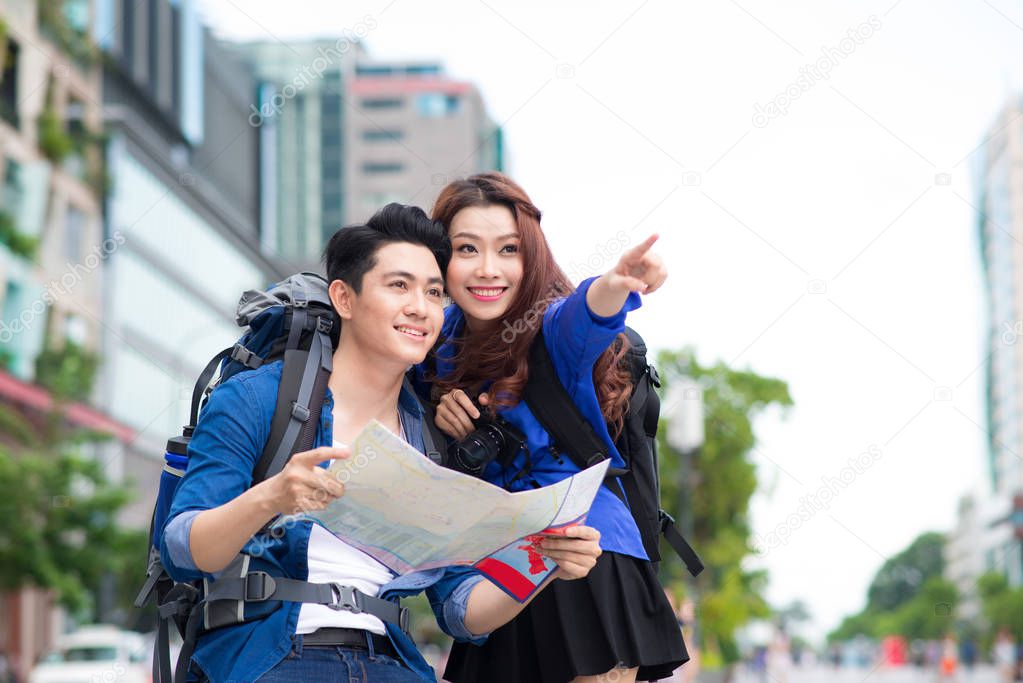 tourists couple looking at map