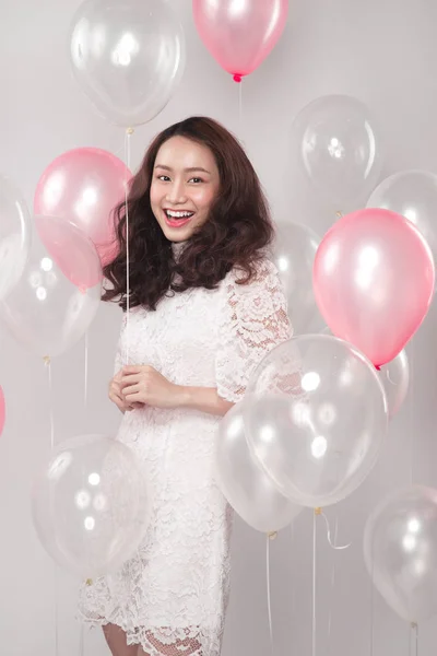 brunette woman with pastel balloons