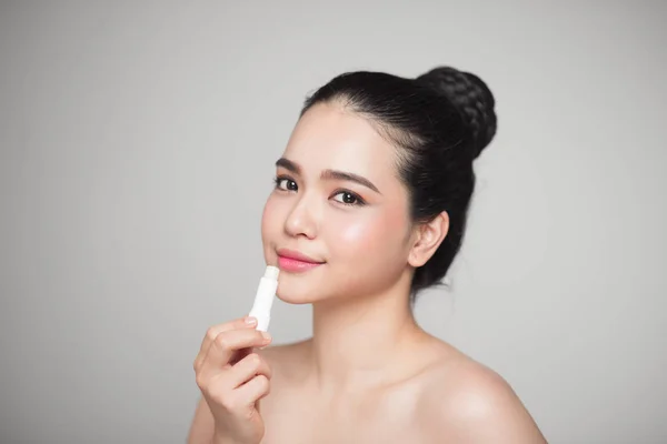 woman applying hygienic lip balm