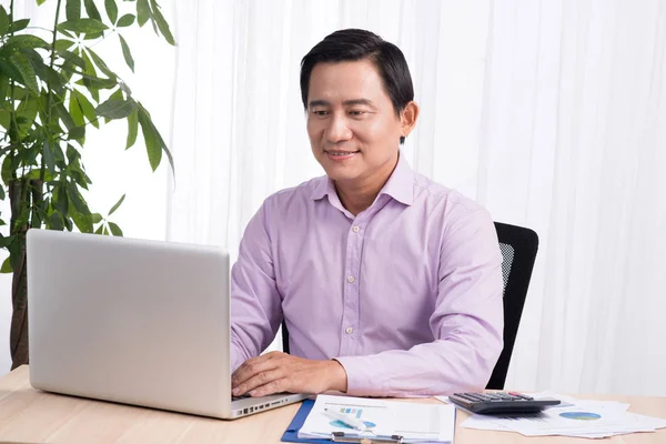 Uomo d'affari seduto con computer portatile — Foto Stock