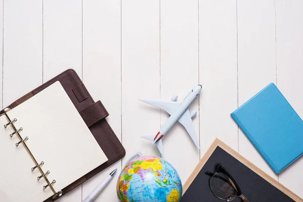 Business trip concept. Airplane and blank open notebook for your